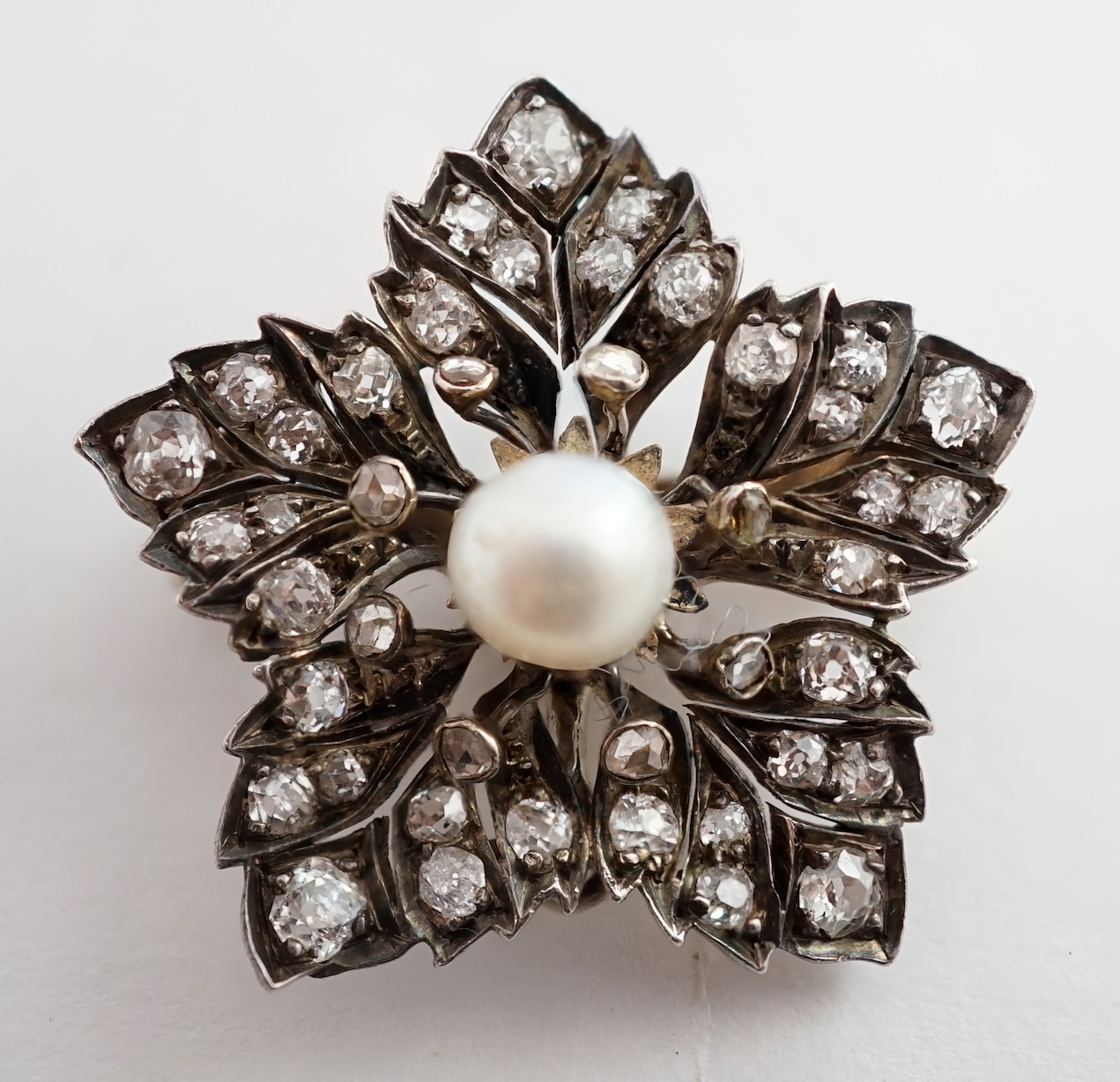 A Victorian gold and silver, pearl and diamond cluster set flower head pendant brooch